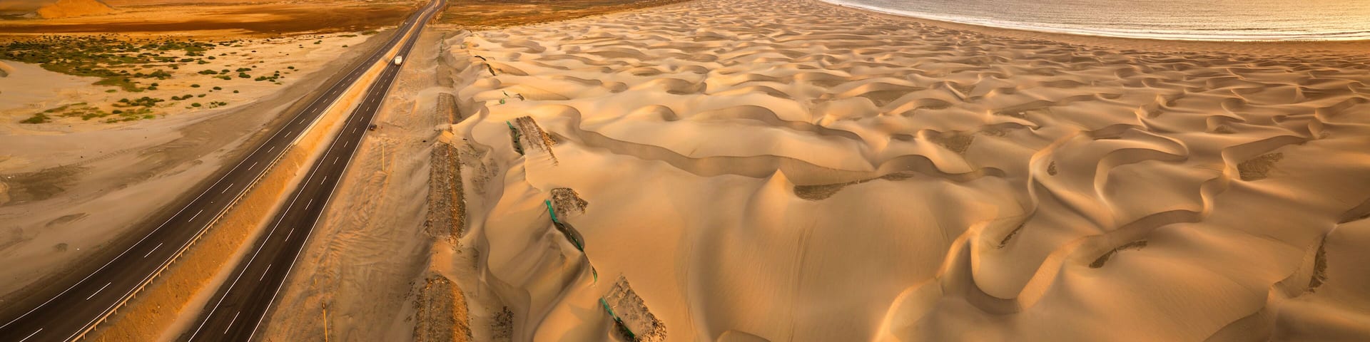 Aerial view of sand dunes in the Peruvian desert at side of the Panamericana international roadway in Ancash, Peru