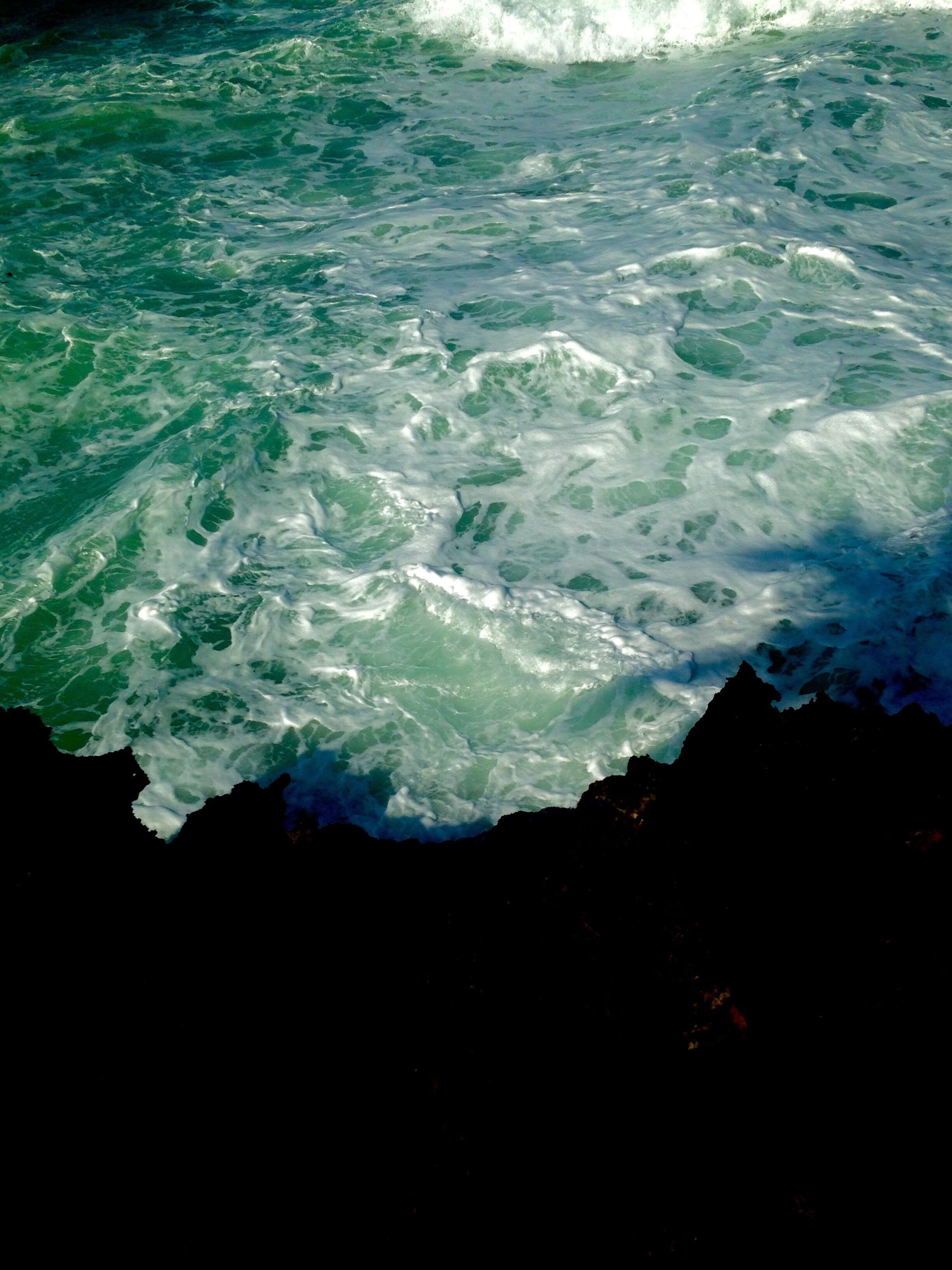 beautiful view of the dark rocks + vibrant waters after our hike through the rainforest!