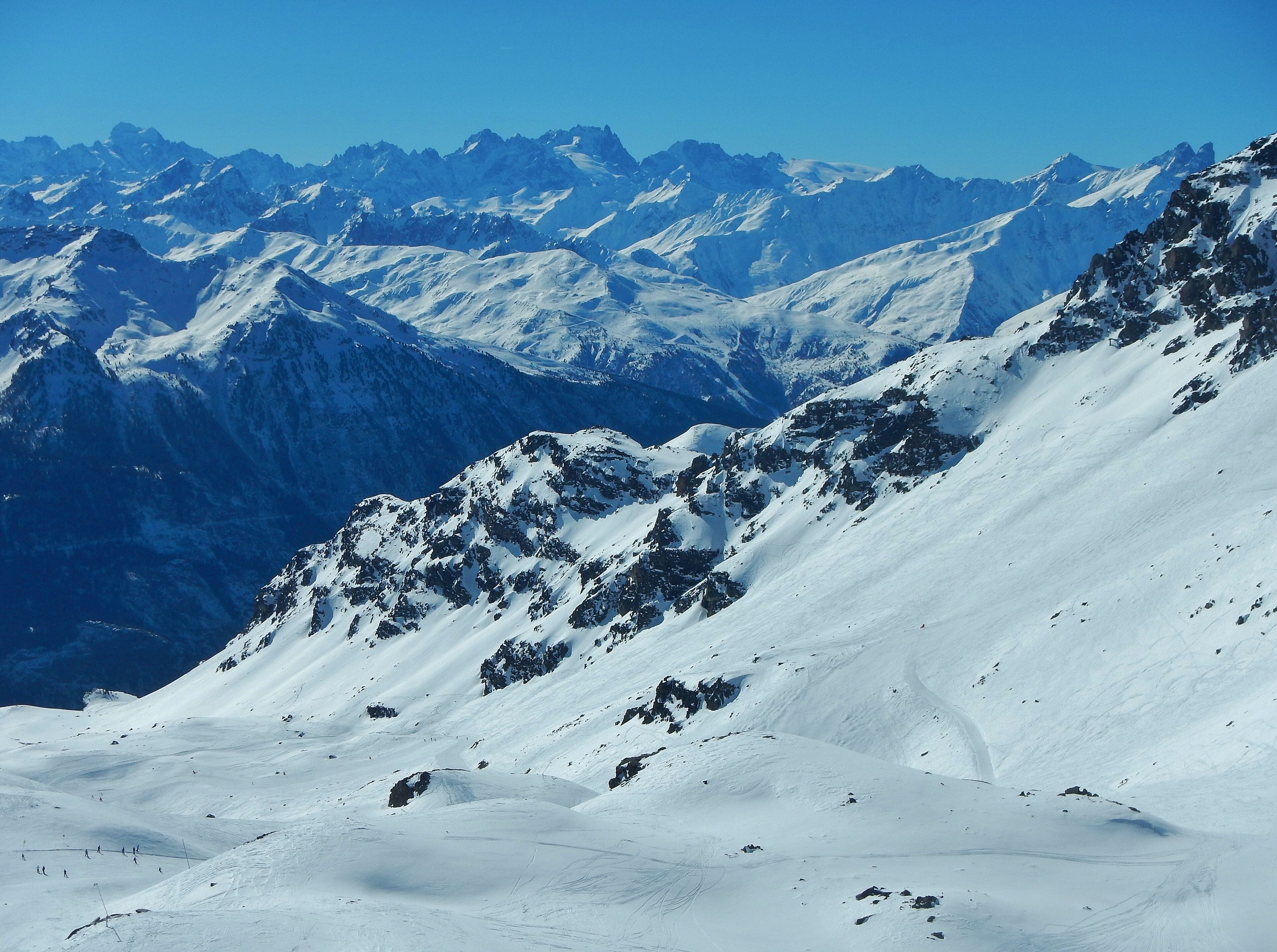 A snow-covered mountain range with clear blue skies.