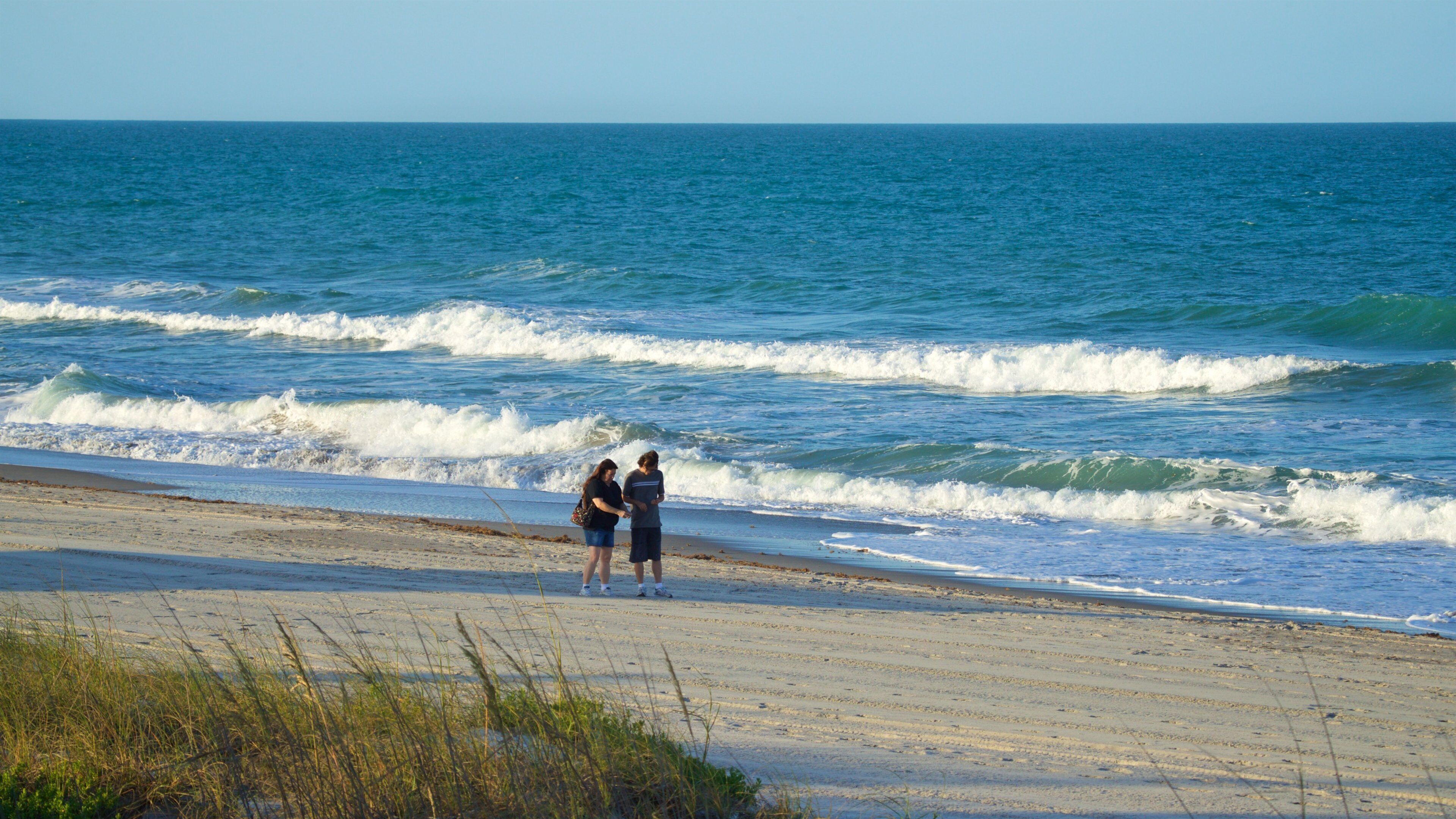 Melbourne Beach which includes a beach and general coastal views as well as a couple