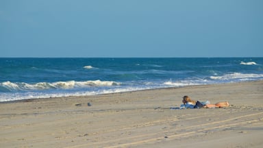 Melbourne Beach which includes general coastal views and a beach as well as a couple