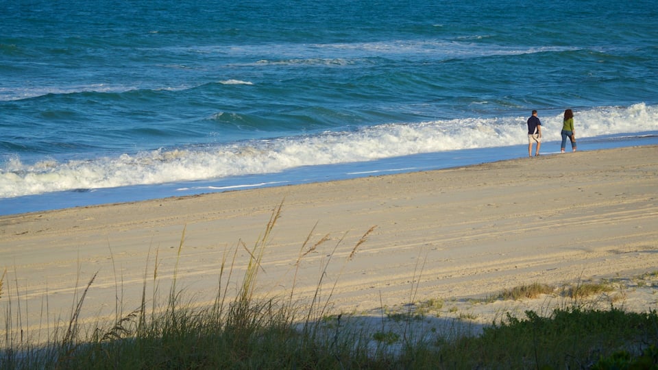 A sandy beach with waves crashing onto the shore.