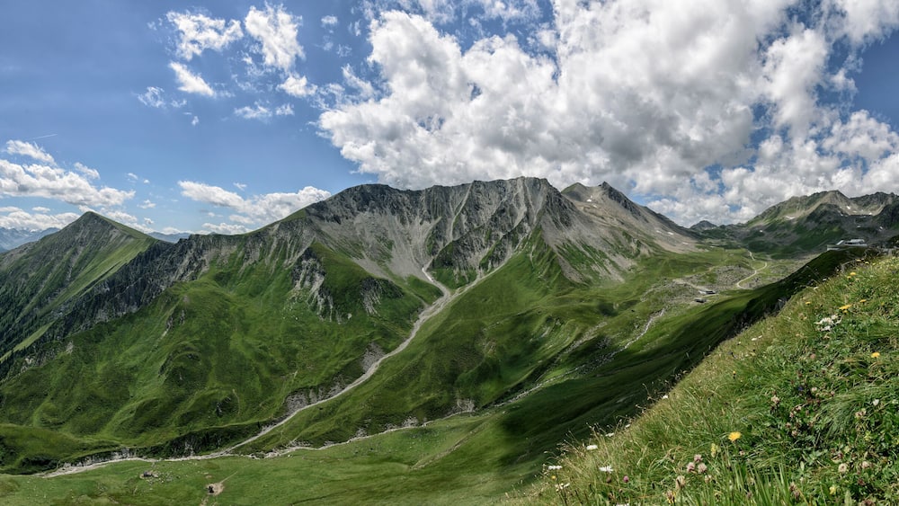A mountainous landscape with green valleys and a clear sky.