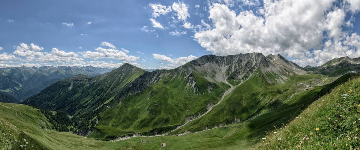 A mountainous landscape with green valleys and a clear sky.