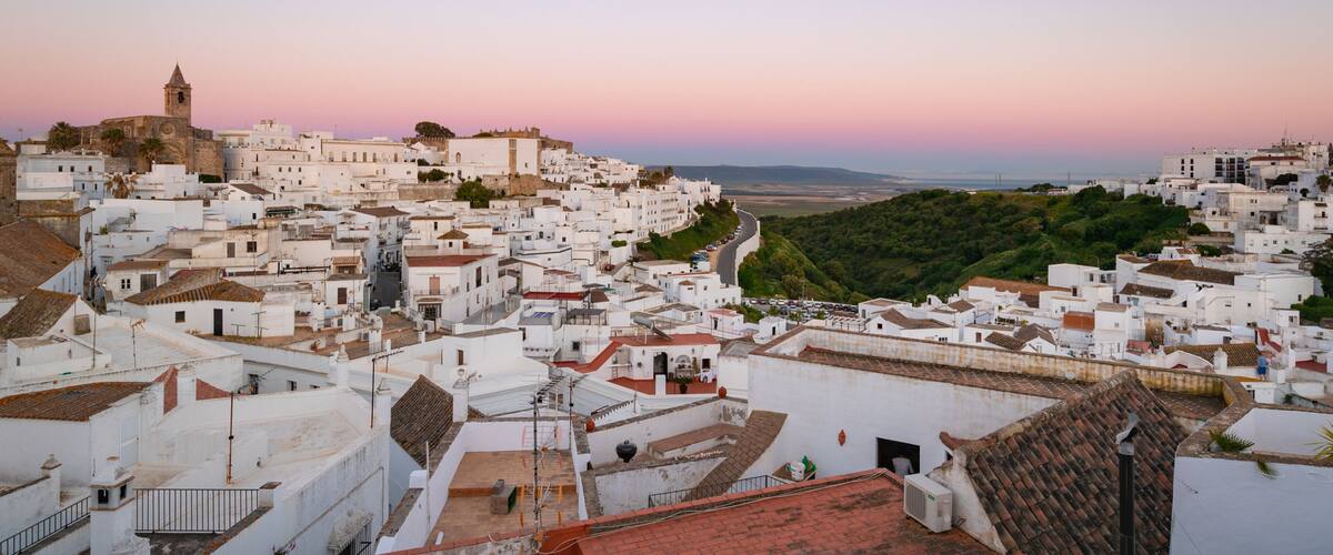 Vejer de la Frontera which includes landscape views, a sunset and a city