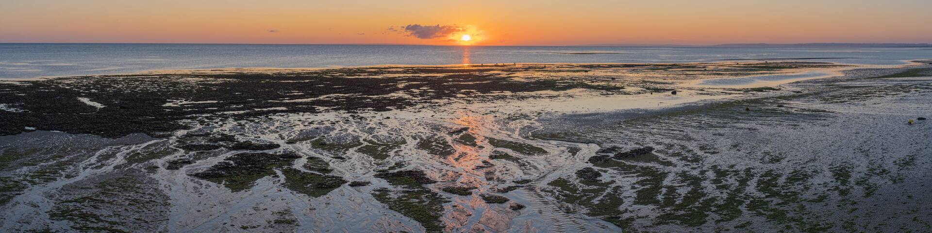 Luc Sur Mer, France - 08 04 2020: Sunrise over Le Havre from the beach