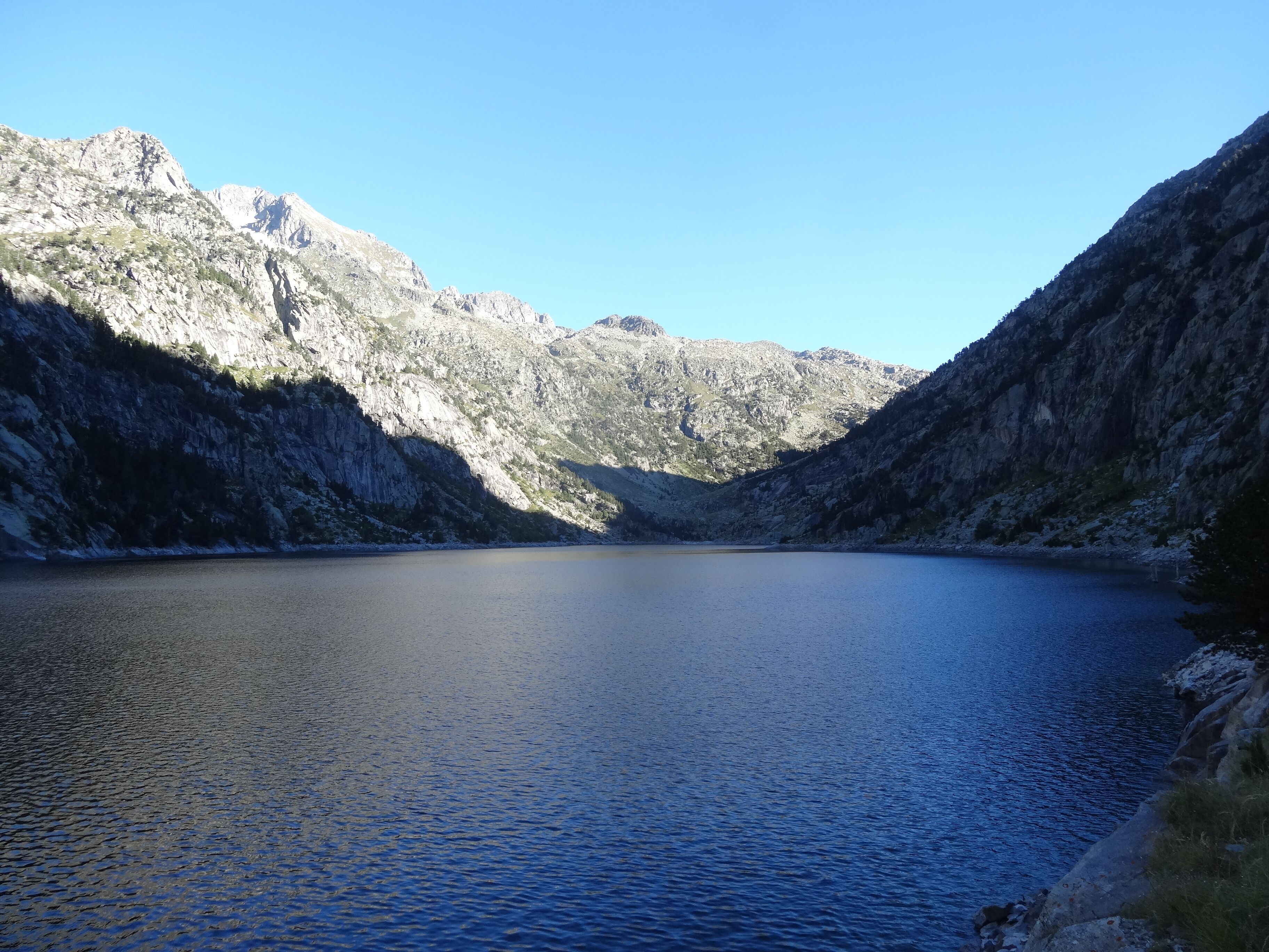 A mountain lake surrounded by rocky cliffs.