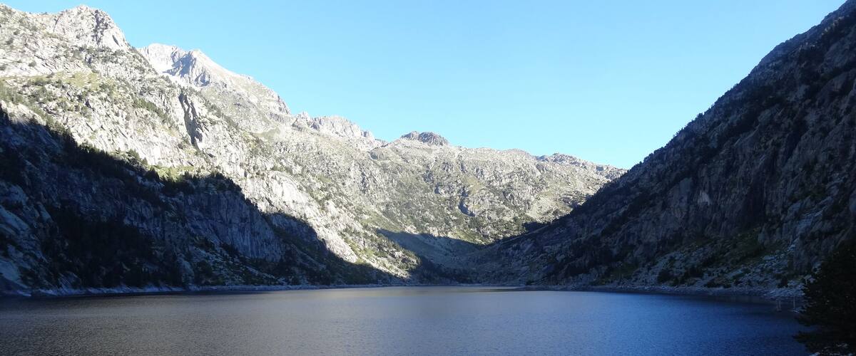 A mountain lake surrounded by rocky cliffs.
