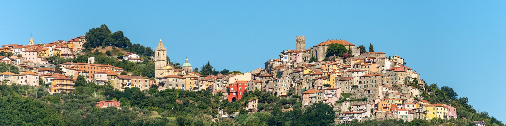 A hillside town with historic buildings and a prominent church tower.