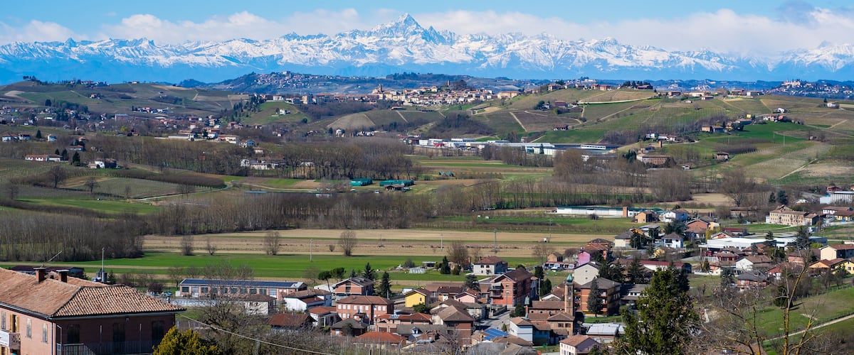 A town with snow-capped mountains in the background.