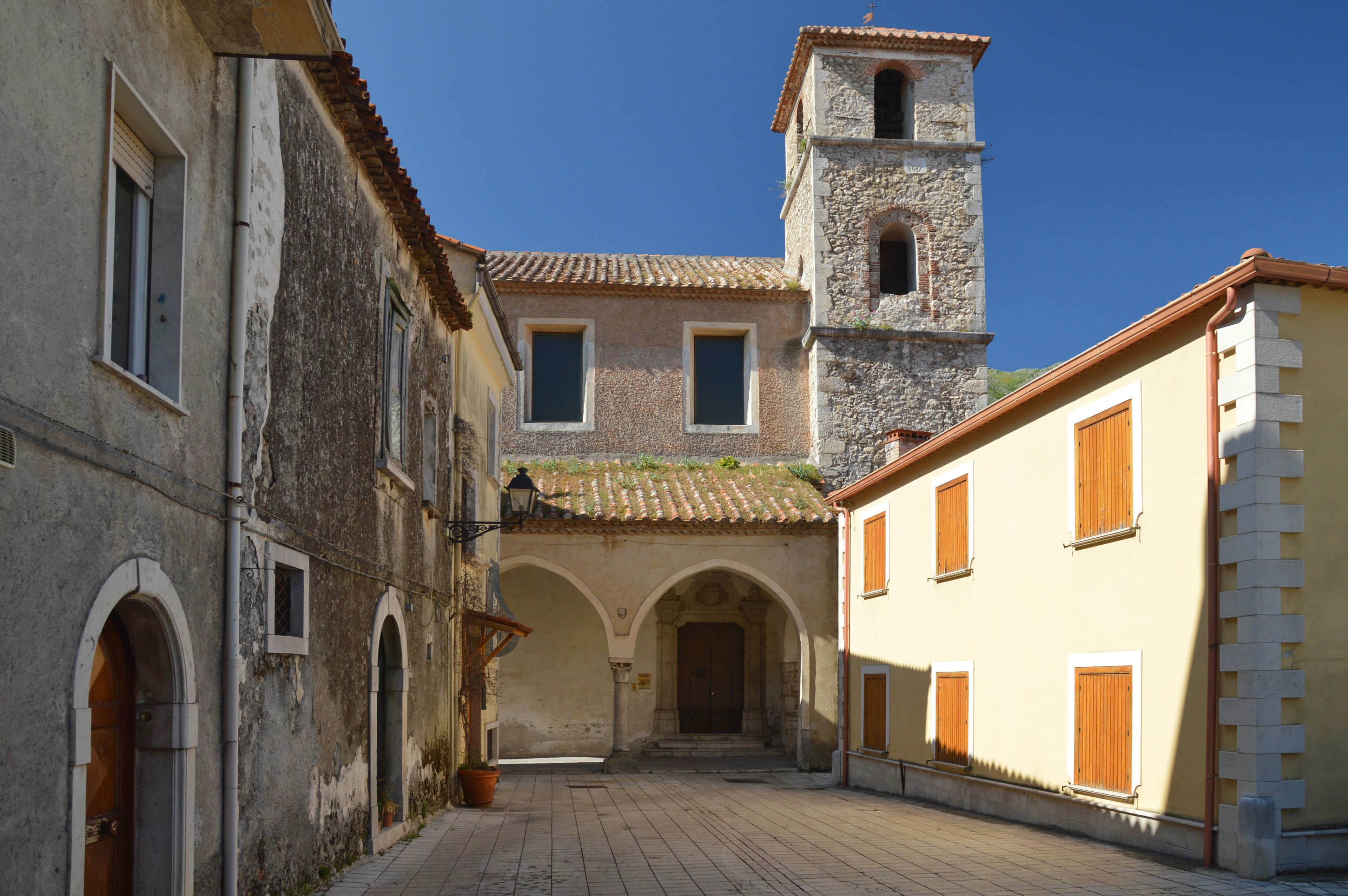 A narrow street among the old houses of an ancient Italian town