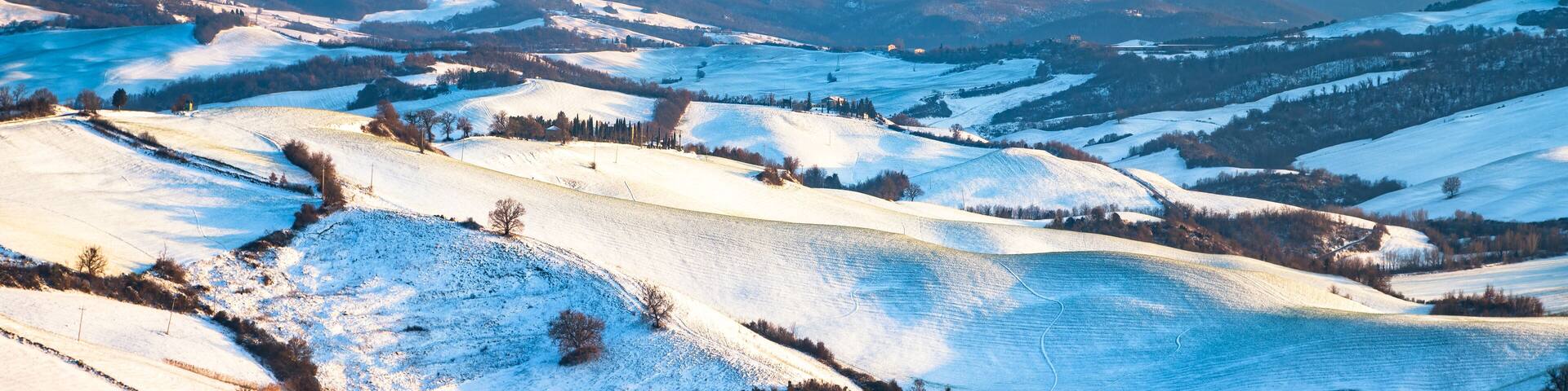 Snow in Tuscany, Radicondoli village, winter panorama. Siena, Italy