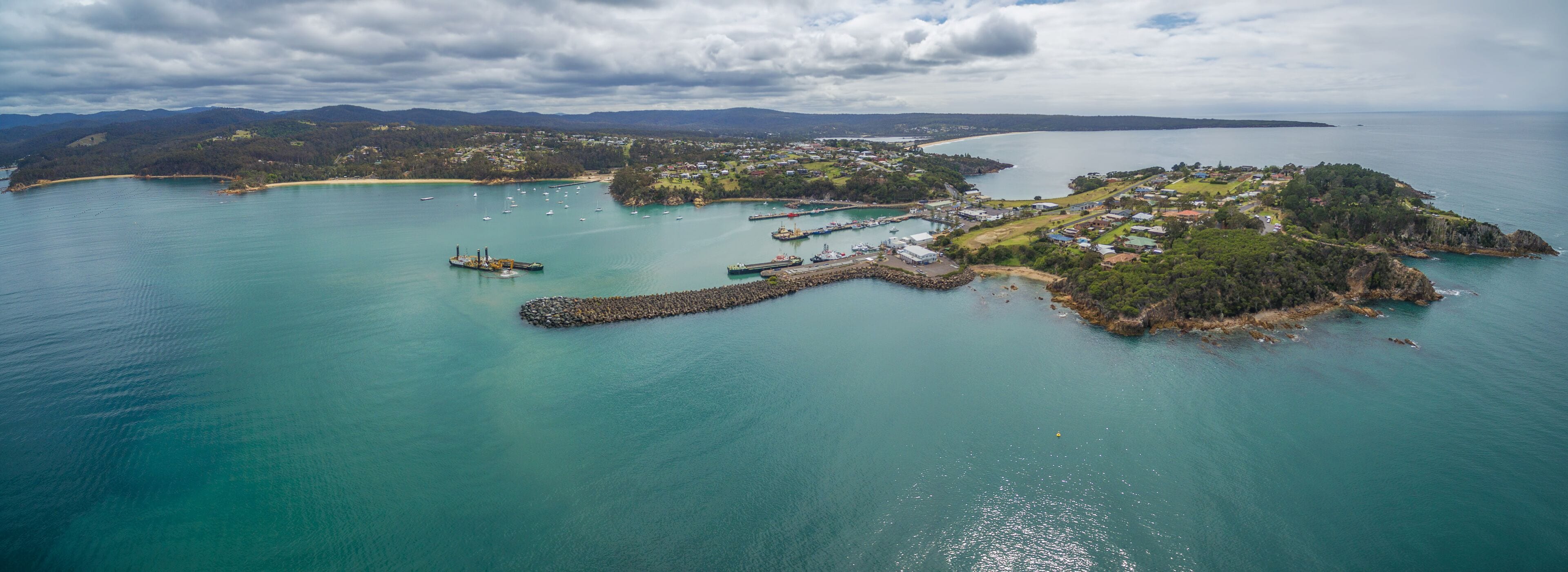 Aerial panorama of the lookout point where people watch for whales and wharf in Eden, NSW, Australia