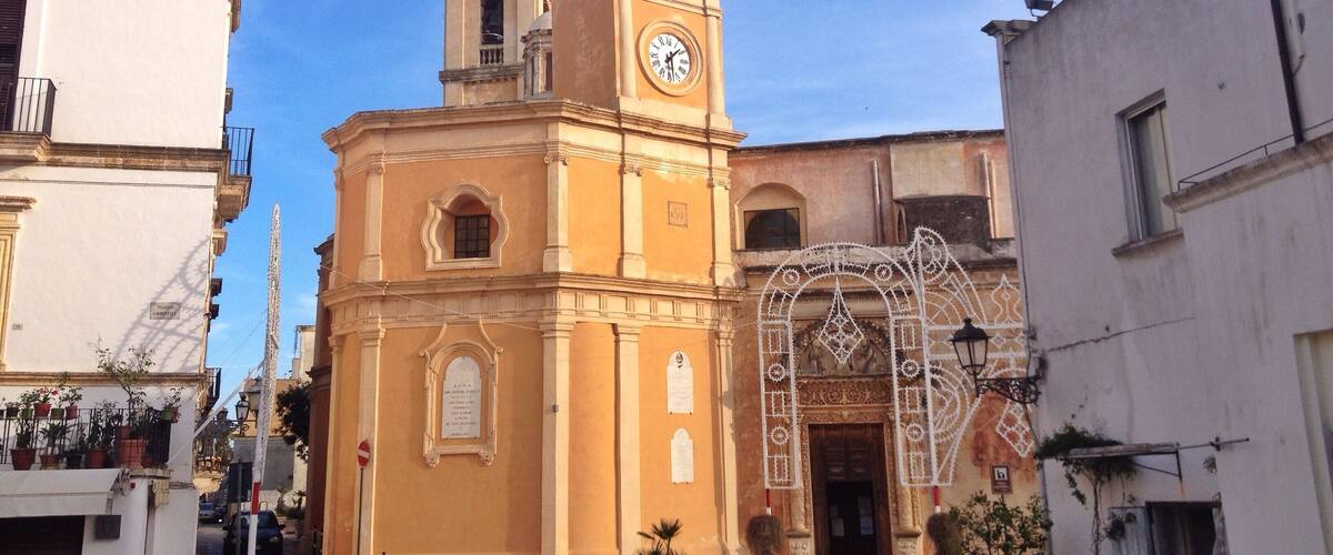 A historic church with a clock tower and a decorative archway.
