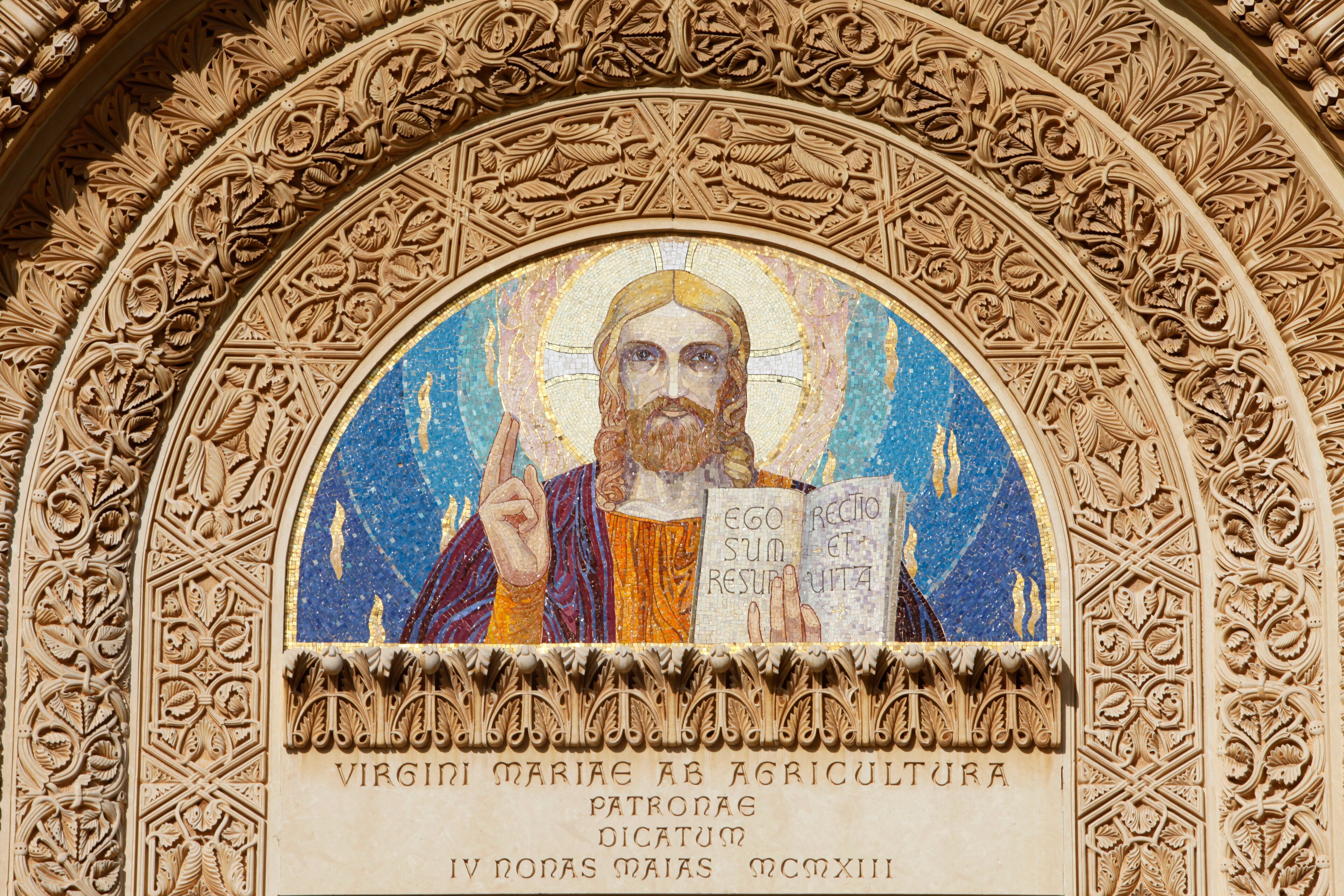 A mosaic of Saint Mary of the Agriculturalists with intricate carvings around it.