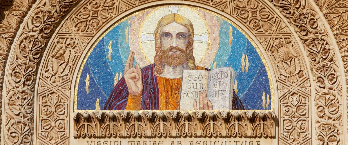 A mosaic of Saint Mary of the Agriculturalists with intricate carvings around it.