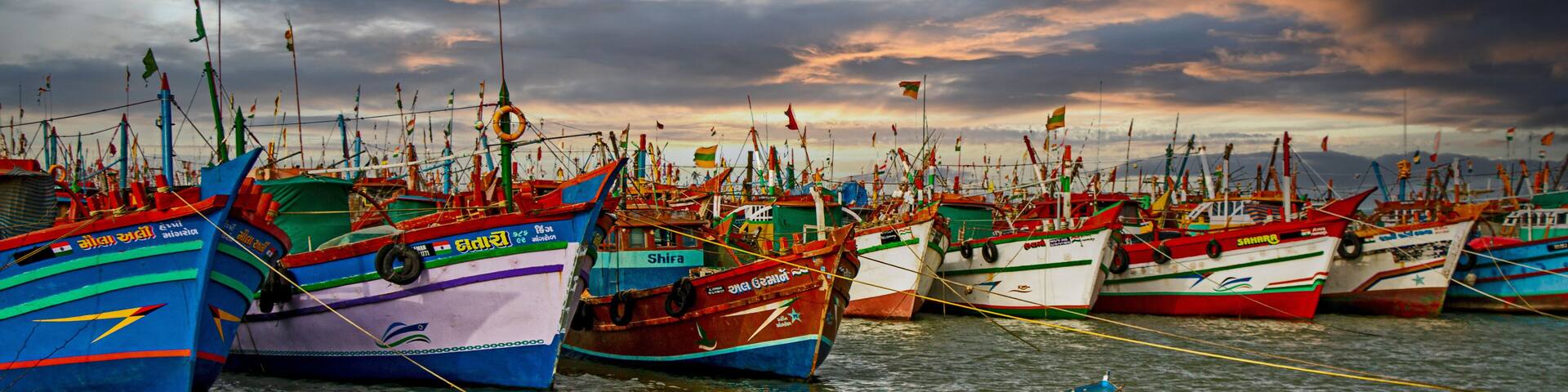 Fishing boats in the harbour on Gujarat coast in India