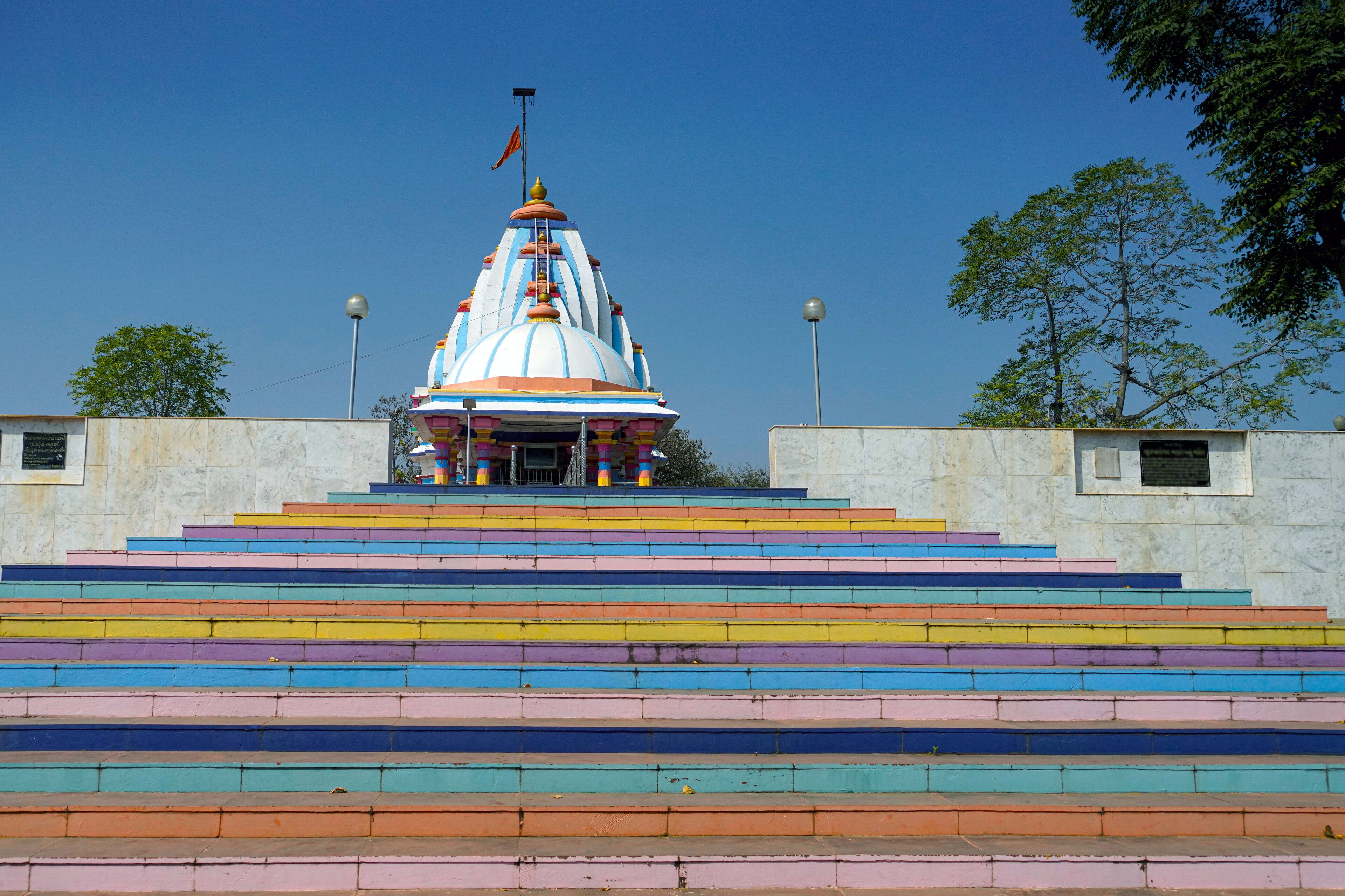 A temple with a colorful staircase leading up to it.