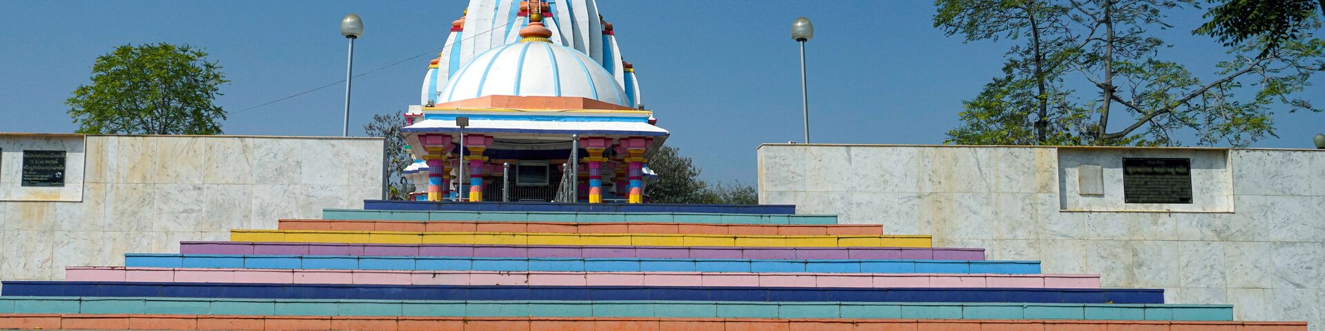 A temple with a colorful staircase leading up to it.