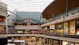 A multi-level shopping mall with various stores including House of Fraser, Claire's, and H&M.