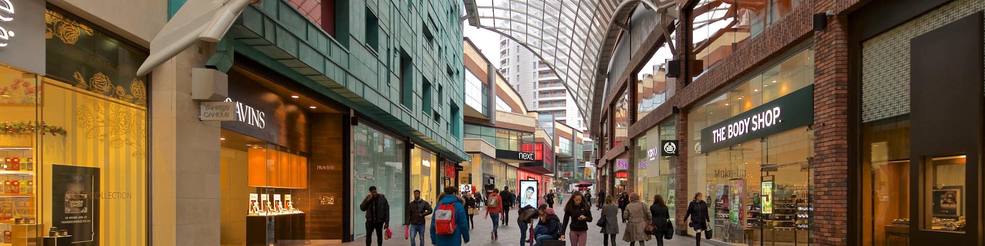 Cabot Circus Shopping Centre featuring shopping and street scenes as well as a small group of people