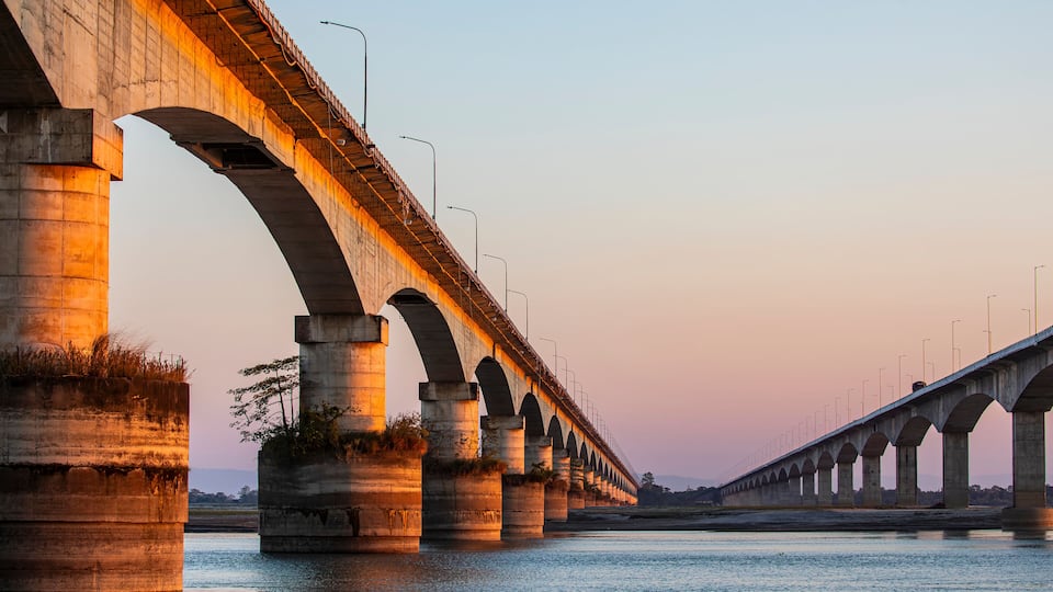 A long bridge with multiple arches spanning a body of water.