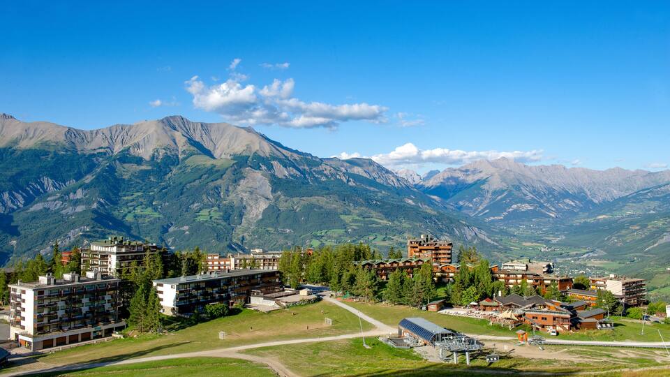 A mountainous landscape with a ski resort and buildings.