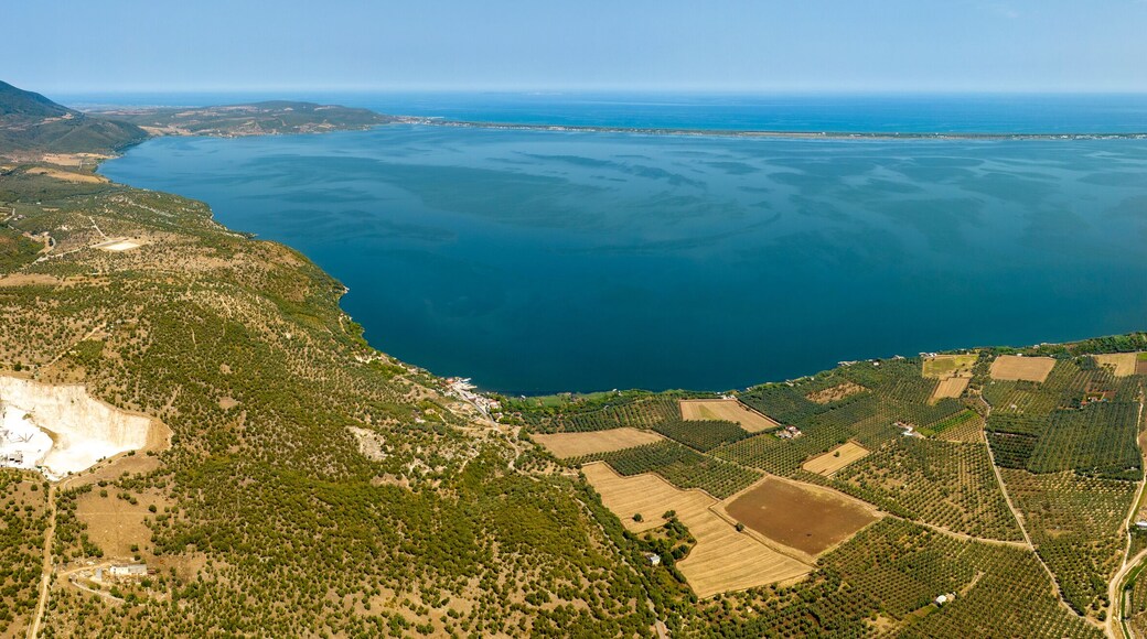 Panoramic aerial view of Varano Lake. It is a coastal lake located in the province of Foggia, in Gargano, Puglia, Italy. In the background is the Adriatic Sea.