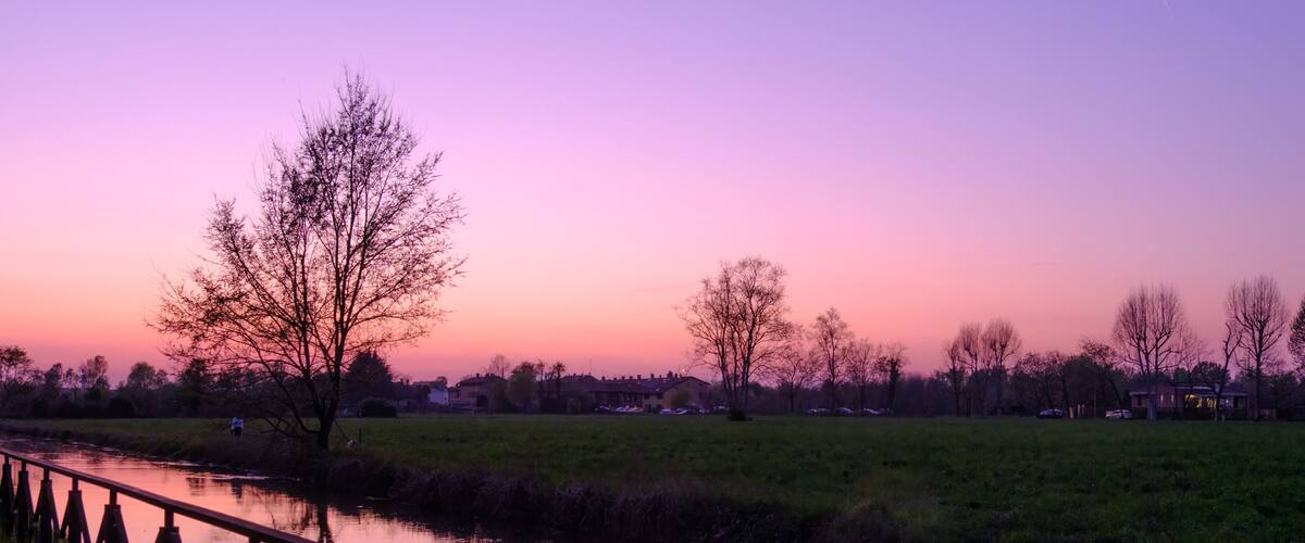 Country landscape along the Canal of Martesana, Milan, Italy, at sunset