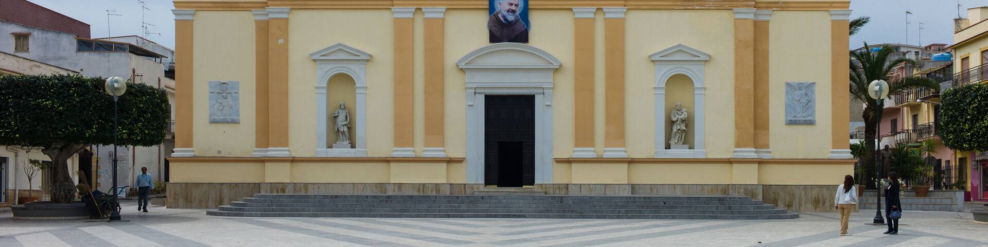 Balestrate Church Oratorio Chiesa Madre Sant’Anna Balestrate with a picture of the famous saint Padre Pio above the entrance and Square in Sicily, Italy