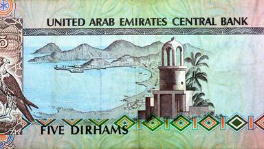 Reverse side of 5 five Emirates Dirhams banknote of the United Arab Emirates, currency of the UAE issued 1982 with Imam Salem Al Mutawa Mosque or Al Jamaa mosque in Sharjah, Khor Fakkan and a falcon