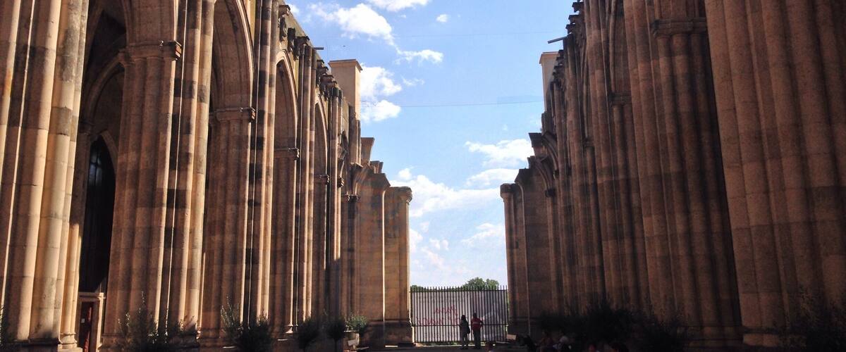 A cathedral with tall, arched windows and columns.