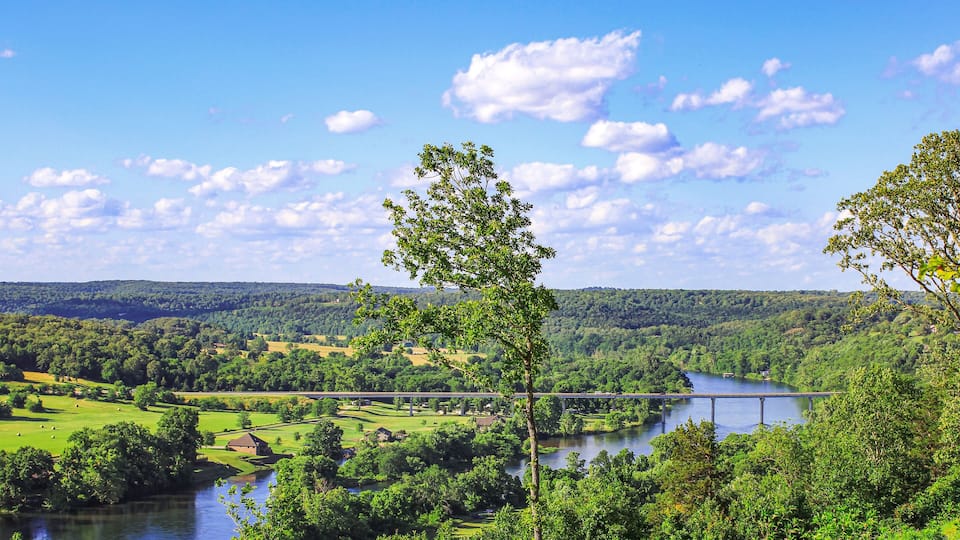 A river, a bridge, and a forested landscape.