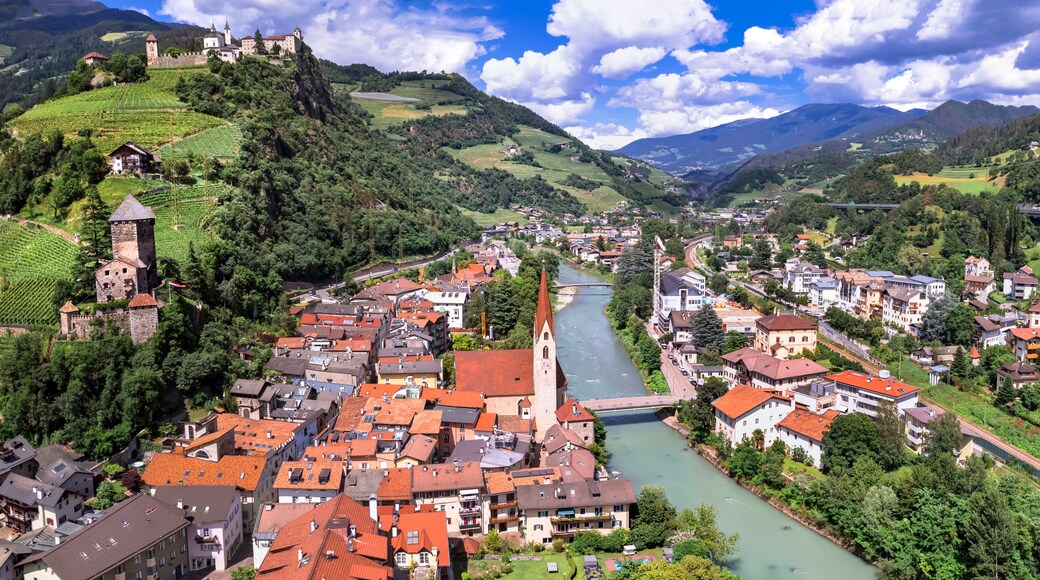 Scenic beautiful places of northern Italy. Charming village Chiusa surrounded by Dolomites mountains. panoramic arerial view. South Tyrol, Bolzano province
