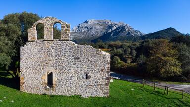 View from a drone of the ruins of the hermitage of San Julian in the Liendo Valley in Cantabria, Spain, Europe