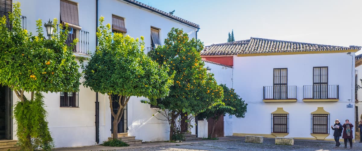 cute and narrow streets with white facades of the old town of Ronda, a town located in Andalusia, Spain
