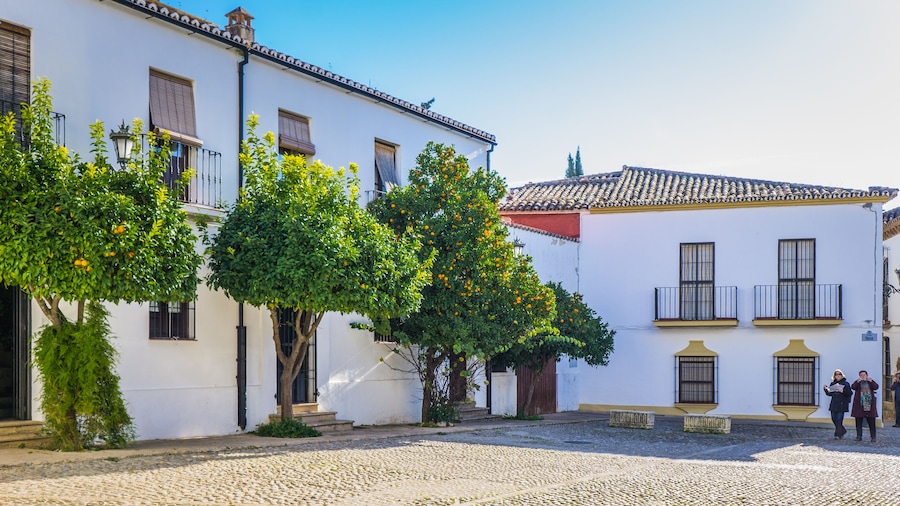 cute and narrow streets with white facades of the old town of Ronda, a town located in Andalusia, Spain