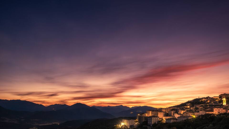 Dawn breaking over the town of Sartene in southern Corsica with the Bavella mountains in the distance