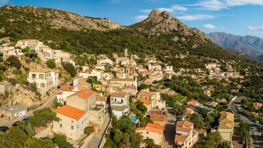 Lumio Corsica France aerial drone 3:1 panorama sunny stone houses mountain background Balagne region authentic village travel destination world print high resolution