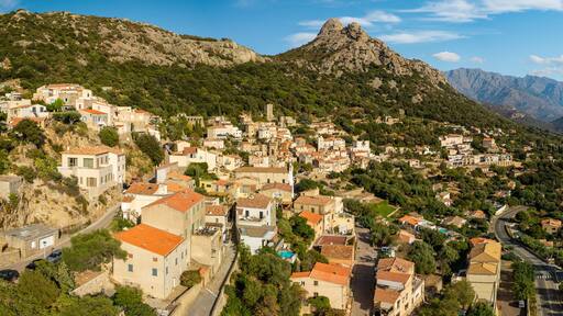 Lumio Corsica France aerial drone 3:1 panorama sunny stone houses mountain background Balagne region authentic village travel destination world print high resolution