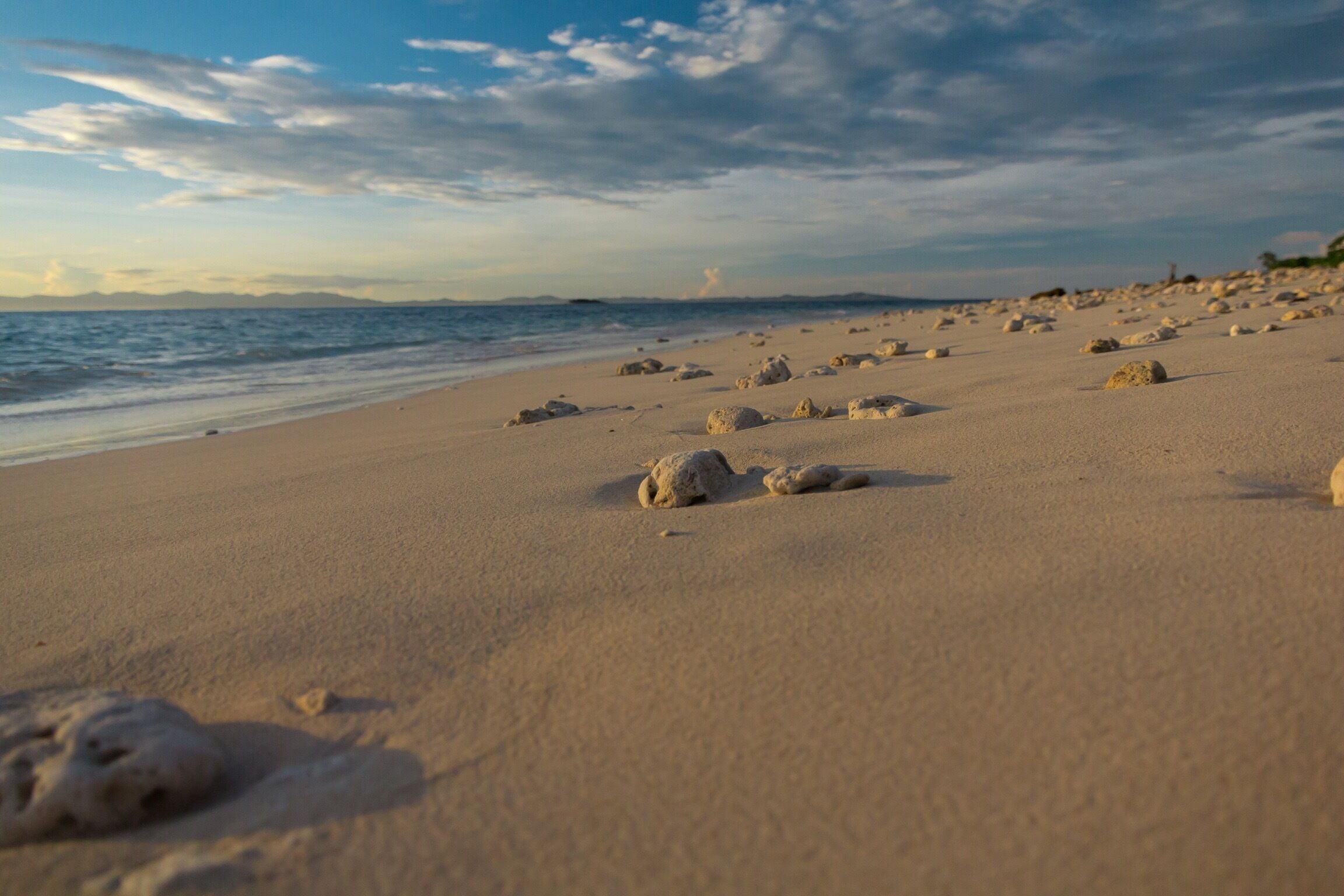 Little stones scattered along the beach like footprints