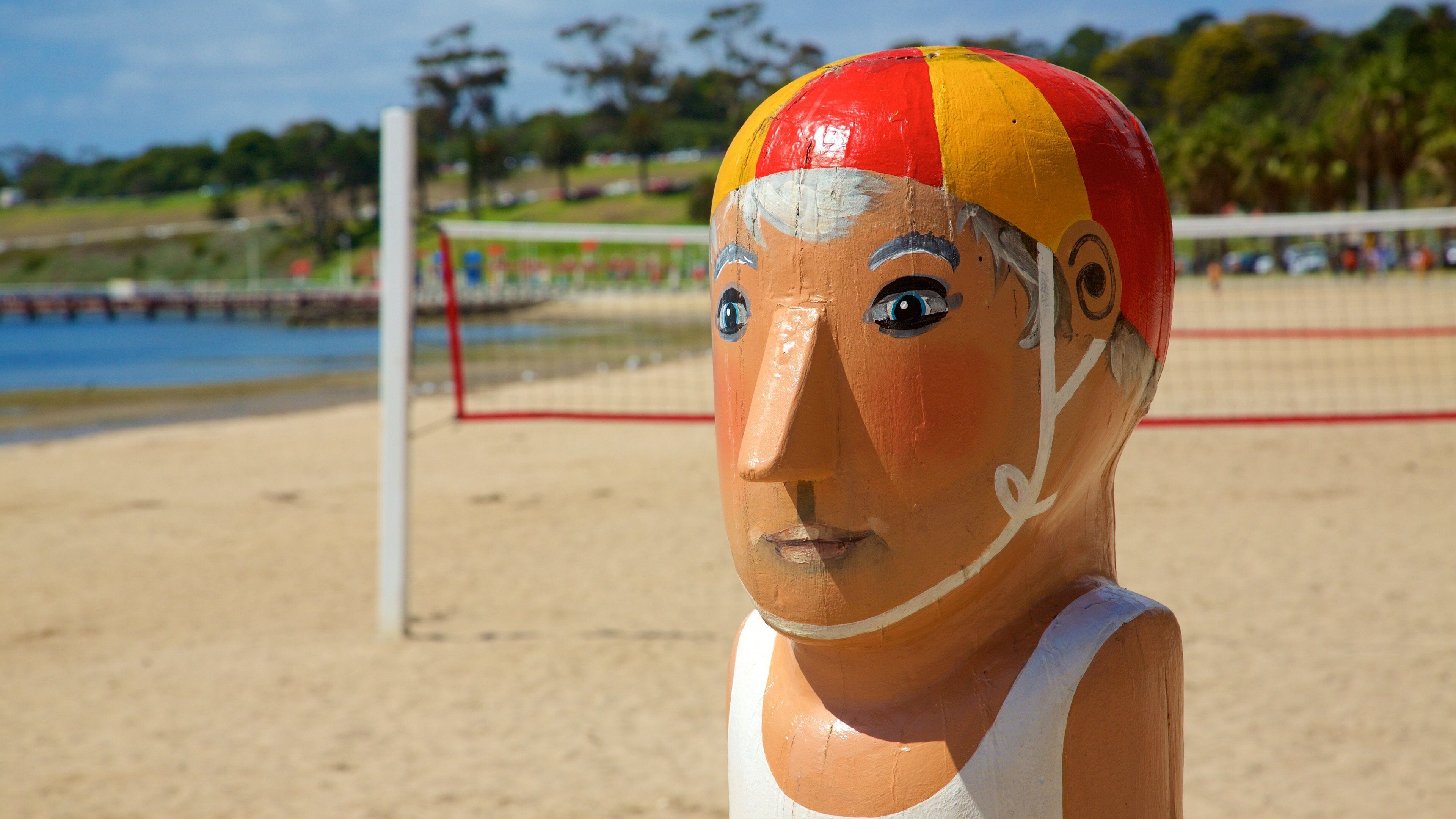 A beach volleyball net with a volleyball.