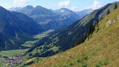 A valley with a small town surrounded by mountains.