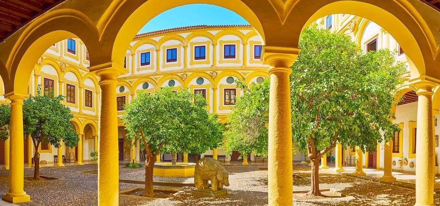 Panorama of the courtyard of Episcopal Palace with orange tree garden, Cordoba, Spain