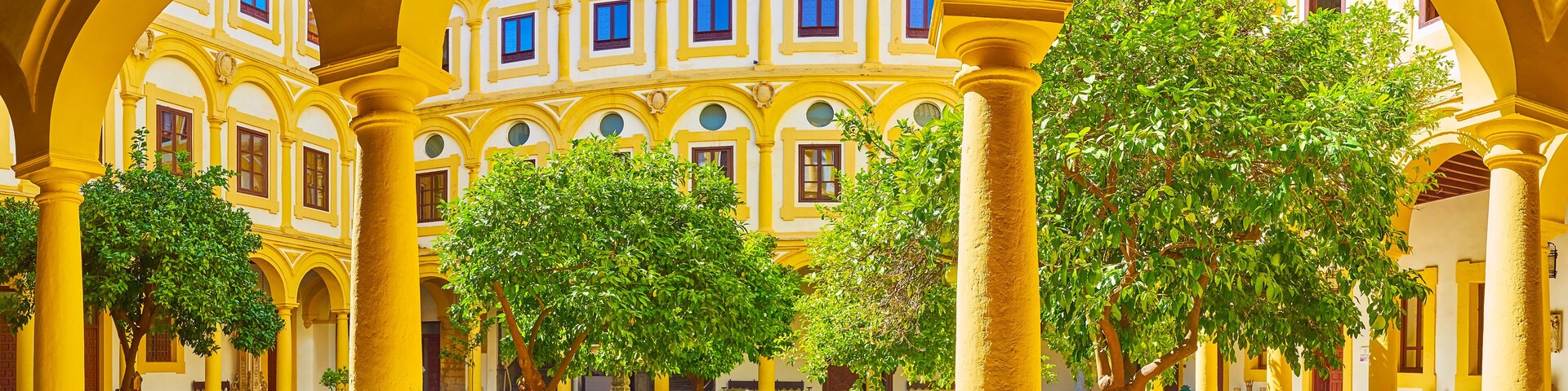Panorama of the courtyard of Episcopal Palace with orange tree garden, Cordoba, Spain