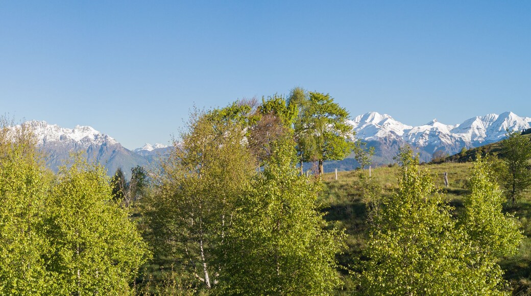 Drone aerial view to the Orobie Alps in a clear and blue day. Fresh snow on the top of mountain in spring. Panorama at Farno Mountain, Bergamo, Italy.