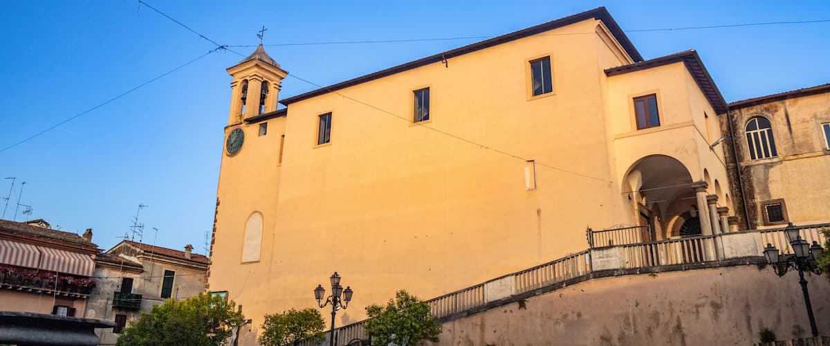 The Convent of S. Maria delle Grazie, in Santa Maria square. The bell tower with the clock. The blue sky at sunset. Zagarolo, Province of Rome, Lazio, Italy