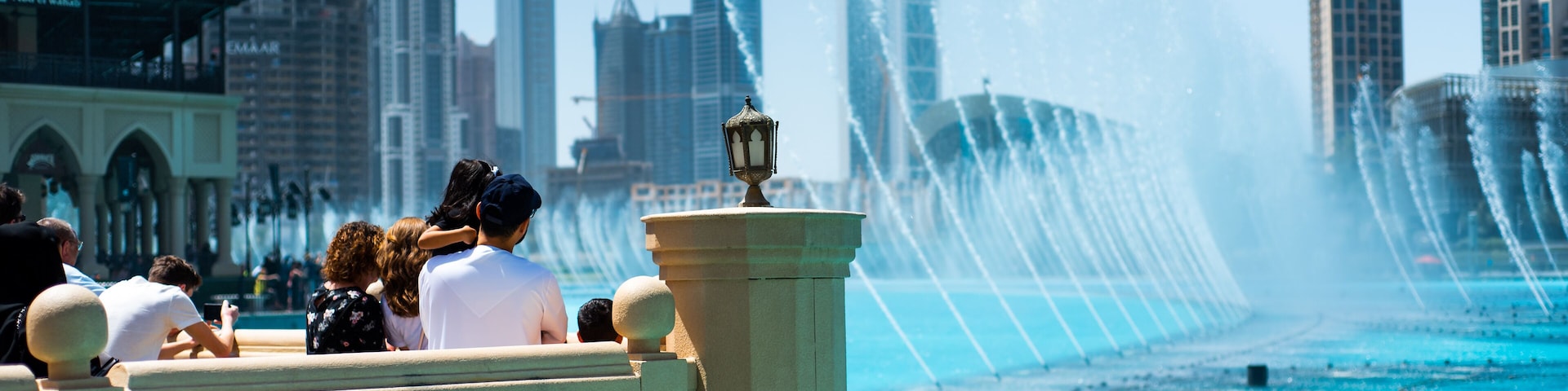 Dubai, United Arab Emirates - March 26, 2018: People gather around the Dubai mall fountain to see the water show