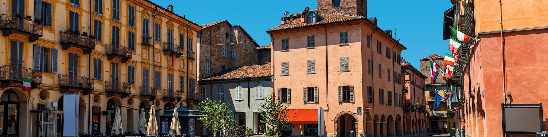 Old town square and medieval towers in Alba, Italy.