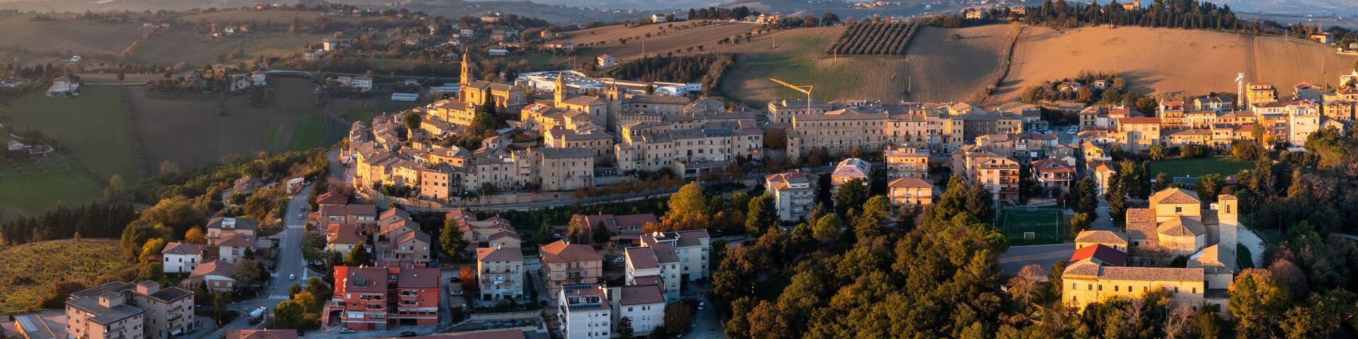 aerial panorama view of the village of Morrovalle in Marche Province in Italy in warm evening light